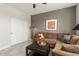 Cozy living room featuring a large couch, decorative art, and storage closet at 16514 W Sandia Park Dr, Surprise, AZ 85374