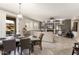 Open-concept living and dining area with a fireplace, recessed lighting, and access to outdoor patio at 16514 W Sandia Park Dr, Surprise, AZ 85374