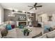 Inviting living room showcasing a modern fireplace, sleek shelving, and comfortable seating arrangement at 16514 W Sandia Park Dr, Surprise, AZ 85374