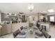 Bright open floor plan with a fireplace, large TV, and access to the kitchen, ideal for entertaining at 16514 W Sandia Park Dr, Surprise, AZ 85374