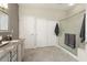 Well-maintained main bathroom boasts tiled floors, granite counters, a large shower, and linen closets at 16514 W Sandia Park Dr, Surprise, AZ 85374