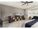 Bright and spacious main bedroom offers tiled floors, a neutral palette, and lots of natural light from a large window at 16514 W Sandia Park Dr, Surprise, AZ 85374