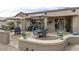 Expansive patio with multiple seating arrangements, grill, and a covered area at 16514 W Sandia Park Dr, Surprise, AZ 85374