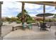 Inviting outdoor patio area complete with seating and mature landscaping at 16514 W Sandia Park Dr, Surprise, AZ 85374