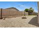 Backyard featuring desert landscaping, block wall, putting green, and string lights at 17292 W Pinnacle Vista Dr, Surprise, AZ 85387