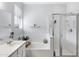 Bright bathroom features a soaking tub with a shower and glass door enclosure at 17292 W Pinnacle Vista Dr, Surprise, AZ 85387