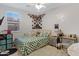 Bedroom with bright window, bed, desk and personalized decor at 17292 W Pinnacle Vista Dr, Surprise, AZ 85387