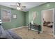 Comfortable bedroom with stylish decor, wood flooring, and a ceiling fan at 17292 W Pinnacle Vista Dr, Surprise, AZ 85387