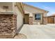 Inviting front entrance with stone pillars, a 'welcome' sign, and convenient garage access at 17292 W Pinnacle Vista Dr, Surprise, AZ 85387