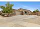 Charming single-story home featuring stone accents, a well-manicured lawn, and a welcoming facade at 17292 W Pinnacle Vista Dr, Surprise, AZ 85387