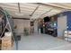 Spacious garage with epoxy floors, built-in storage, and a workshop area at 17292 W Pinnacle Vista Dr, Surprise, AZ 85387