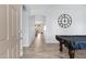 Spacious hallway with stylish wood-look flooring that provides a modern and elegant transition between rooms at 17292 W Pinnacle Vista Dr, Surprise, AZ 85387