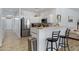 Bright kitchen with stainless steel appliances and counter seating, perfect for casual dining and entertaining at 17292 W Pinnacle Vista Dr, Surprise, AZ 85387