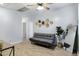 Open living room with tile floors, ceiling fan, and stylish decor with a futon and plant at 17292 W Pinnacle Vista Dr, Surprise, AZ 85387