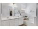 Main bathroom featuring double sinks, a soaking tub, and a separate shower at 17292 W Pinnacle Vista Dr, Surprise, AZ 85387