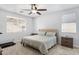 Serene bedroom with neutral tones, ceiling fan, and ample natural light at 17292 W Pinnacle Vista Dr, Surprise, AZ 85387