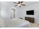 Spacious primary bedroom with a ceiling fan, ensuite bath access, and a large window for natural light at 17292 W Pinnacle Vista Dr, Surprise, AZ 85387