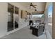 Covered patio features dual ceiling fans, a BBQ, outdoor seating, and convenient sliding glass door access at 17292 W Pinnacle Vista Dr, Surprise, AZ 85387