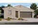 Charming single-story home with a neutral color palette, landscaped yard, and attached two-car garage at 17316 W Eva St, Waddell, AZ 85355