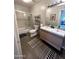 Bright bathroom featuring dual sinks, shower-tub combo, modern lighting, and tile floors at 1823 E Kirkland Ln # C, Tempe, AZ 85281