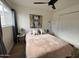 Bright bedroom features a ceiling fan, modern art, and plush pink bedding at 1823 E Kirkland Ln # C, Tempe, AZ 85281