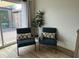 Cozy living room detail with stylish chairs, a plant, and access to a private outdoor patio at 1823 E Kirkland Ln # C, Tempe, AZ 85281