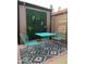 Stylish patio with turquoise metal furniture, decorative greenery, and patterned outdoor rug at 1823 E Kirkland Ln # C, Tempe, AZ 85281