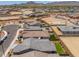 A residential neighborhood amid a desert landscape, featuring new construction, wide streets, and mountain views at 19968 W Flower St, Buckeye, AZ 85396