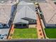 Aerial shot showcasing the backyard with green grass, a patio with furniture, and a grey tiled roof at 19968 W Flower St, Buckeye, AZ 85396