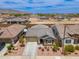 An aerial view of a single-Gathering home featuring desert landscaping, concrete driveway, and mountain views at 19968 W Flower St, Buckeye, AZ 85396