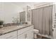 Bathroom featuring a granite countertop, framed art and a shower with a patterned curtain at 19968 W Flower St, Buckeye, AZ 85396