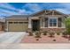 Charming single-story home featuring a stone accent wall and low-maintenance desert landscaping at 19968 W Flower St, Buckeye, AZ 85396