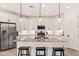 Modern kitchen with white cabinets, granite countertops, and stainless steel appliances at 19968 W Flower St, Buckeye, AZ 85396
