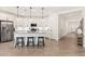 Bright kitchen featuring white cabinets, a large island with seating, and stainless steel appliances at 19968 W Flower St, Buckeye, AZ 85396
