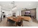 Inviting open-concept living area with sightlines of the dining table, kitchen and living room at 19968 W Flower St, Buckeye, AZ 85396