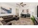 Spacious living room featuring a large sectional, ceiling fan, and stylish decor at 19968 W Flower St, Buckeye, AZ 85396