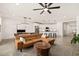 Spacious living room with modern finishes, including a ceiling fan, dining table and chef's kitchen at 19968 W Flower St, Buckeye, AZ 85396