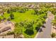 Scenic aerial view of a green park, trees, and walking trail in a residential community at 2102 S Sabrina --, Mesa, AZ 85209