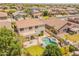 Aerial view of a backyard with pool, spa, covered patio, grass lawn, and mature landscaping at 2102 S Sabrina --, Mesa, AZ 85209