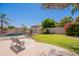 Landscaped backyard featuring a pool, grass lawn, patio area, and mature trees at 2102 S Sabrina --, Mesa, AZ 85209