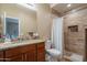 Bathroom boasting granite countertops, tiled shower with recessed shelf, vanity, and a commode at 2102 S Sabrina --, Mesa, AZ 85209