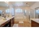 Bright bathroom featuring a large soaking tub, glass shower, and double sink vanity at 2102 S Sabrina --, Mesa, AZ 85209