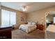 Bedroom showcasing neutral walls, ceiling fan, carpet, a window, and an entrance to another room at 2102 S Sabrina --, Mesa, AZ 85209