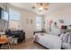 A bedroom featuring natural light from two windows, wood-look flooring, ceiling fan, and a whimsical theme at 2102 S Sabrina --, Mesa, AZ 85209