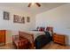 Bedroom featuring a ceiling fan, wooden floor and matching end tables and decor at 2102 S Sabrina --, Mesa, AZ 85209