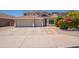 Two-story house boasting a spacious three-car garage and a well-manicured front yard with colorful shrubbery at 2102 S Sabrina --, Mesa, AZ 85209