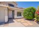 Inviting home entrance with neutral stucco, tiled roof, and landscaped front yard at 2102 S Sabrina --, Mesa, AZ 85209