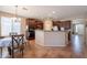 Open kitchen featuring wood cabinets, modern appliances, an island, and an adjacent dining area at 2102 S Sabrina --, Mesa, AZ 85209