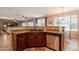 Open kitchen with dark wood cabinets, granite countertops, and stainless steel appliances at 2102 S Sabrina --, Mesa, AZ 85209