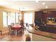 Open kitchen featuring dark wood cabinets, modern appliances, breakfast bar, and dining area at 2102 S Sabrina --, Mesa, AZ 85209